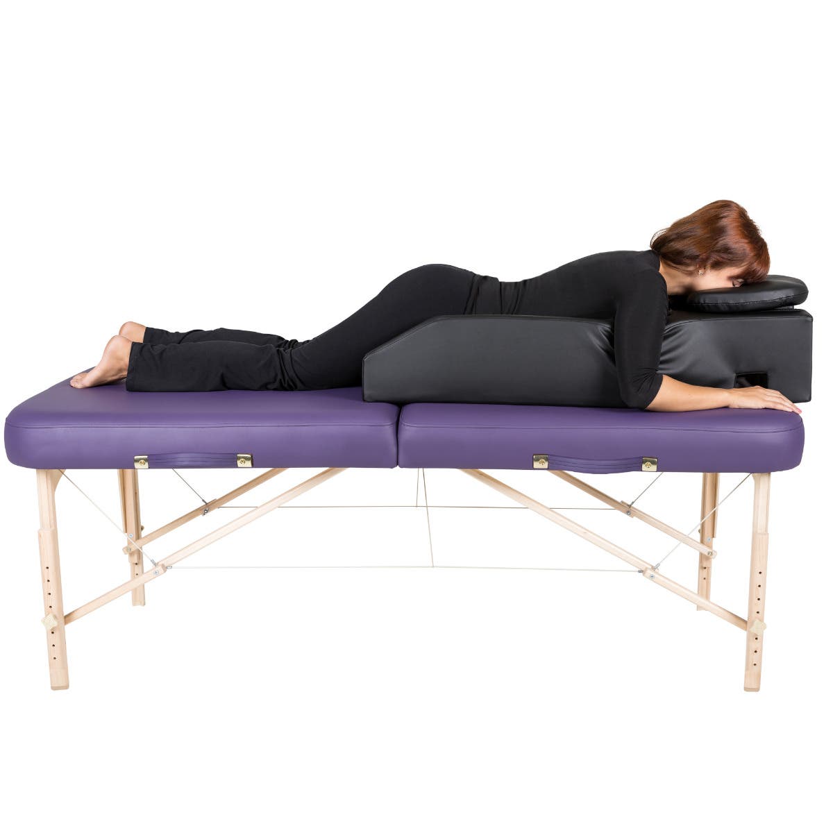 Pregnant woman lying face down on the prenatal cushion at Organic Mechanics Greenville